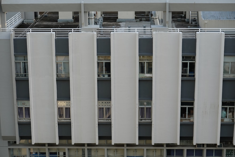 a tall building with lots of windows next to a parking lot