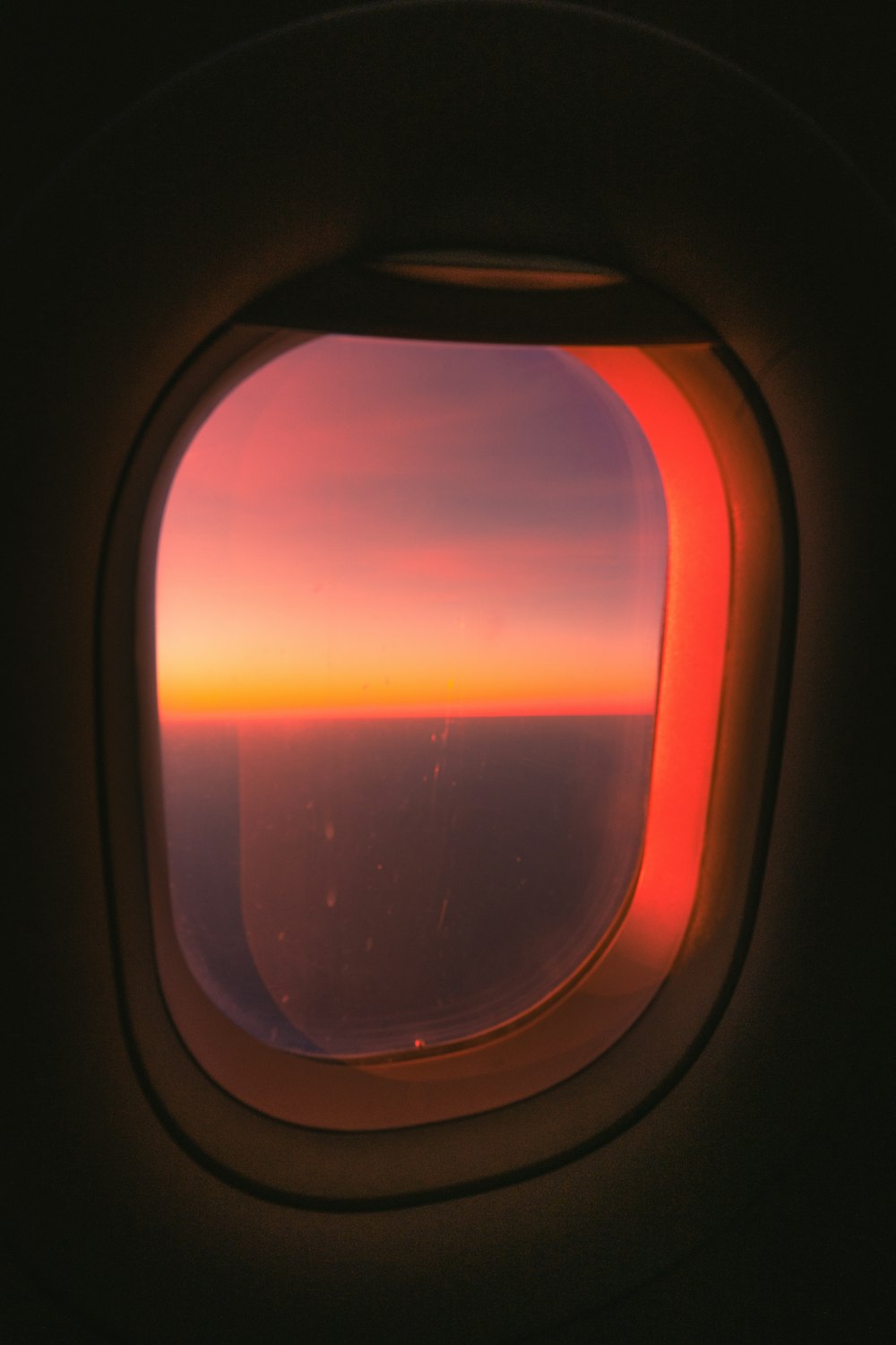 an airplane window with a view of the sky