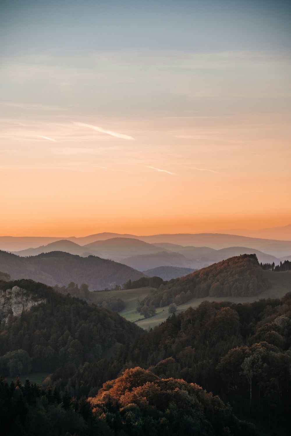 a view of a mountain range with trees in the foreground