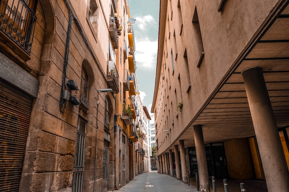 a narrow city street lined with tall buildings