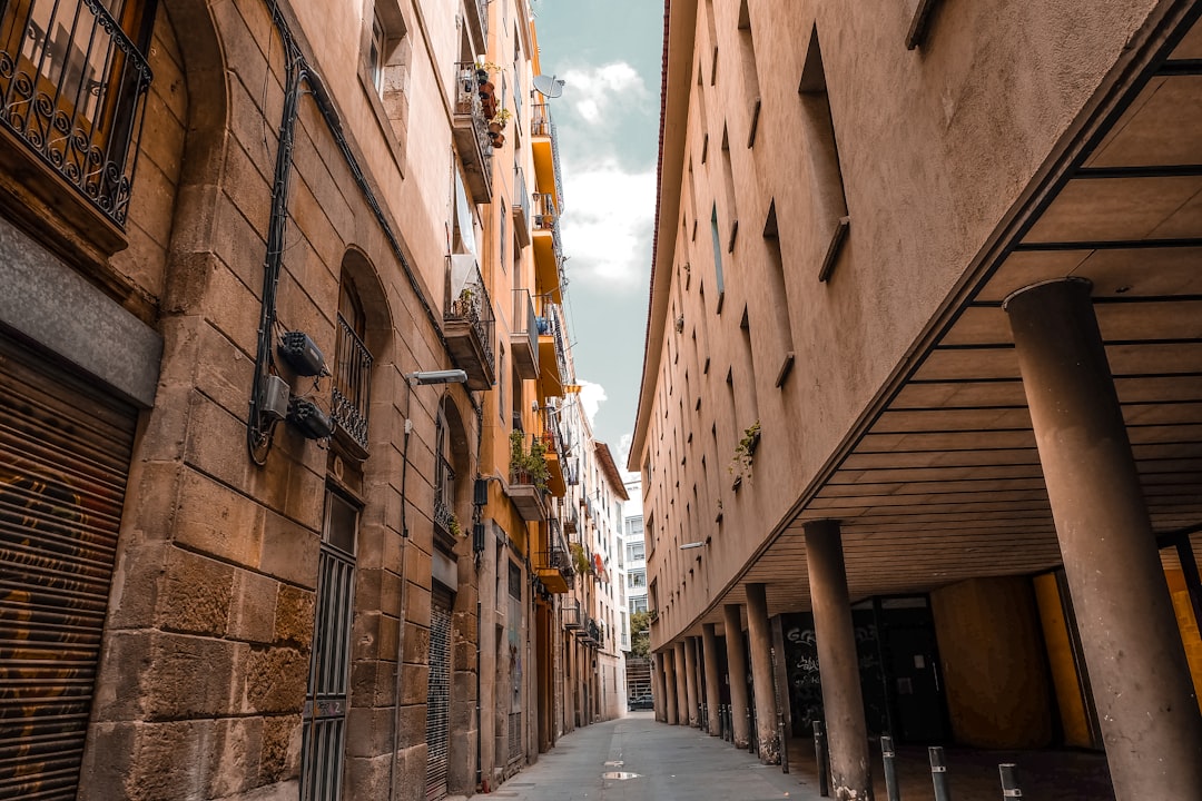 a narrow city street lined with tall buildings,