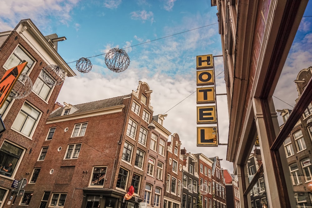 a hotel sign hanging from the side of a building