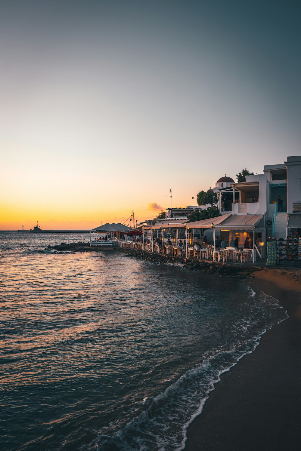 a sunset view of a restaurant on the beach