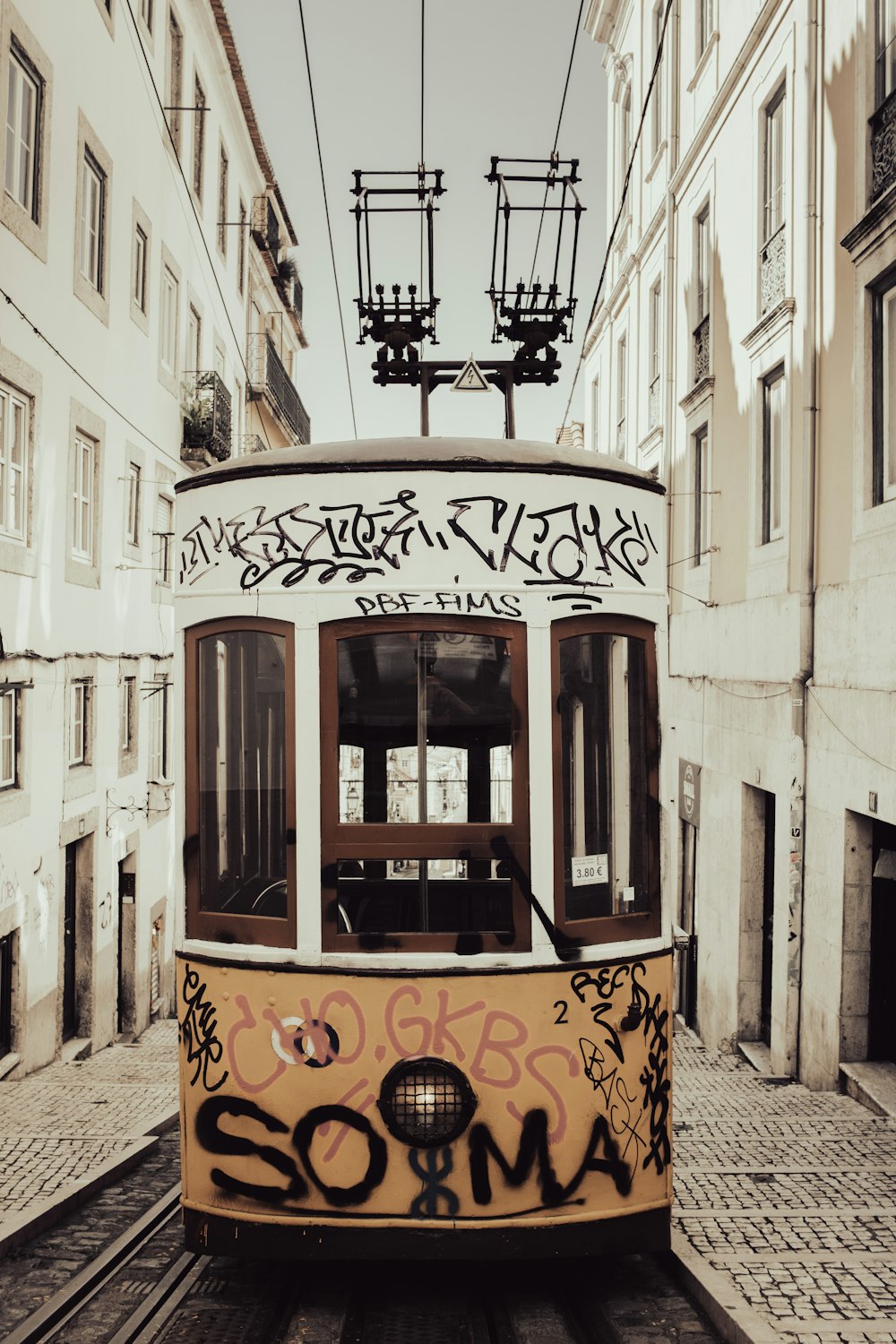 a trolley car with graffiti on the side of it