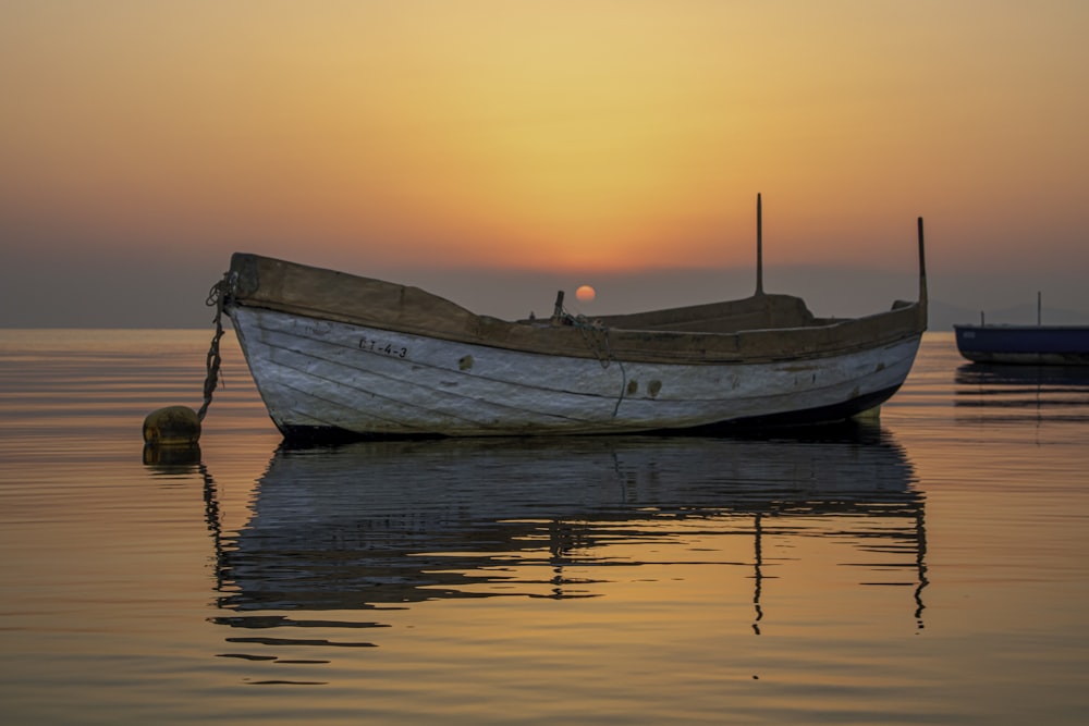 a boat sitting on top of a body of water