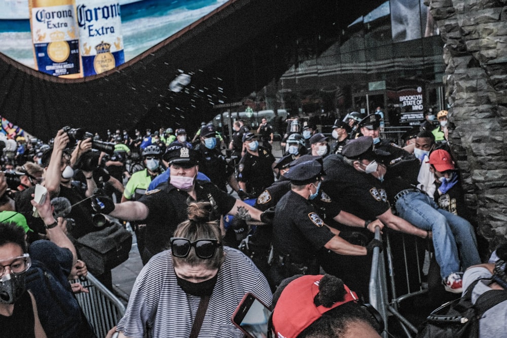 a crowd of people standing around each other