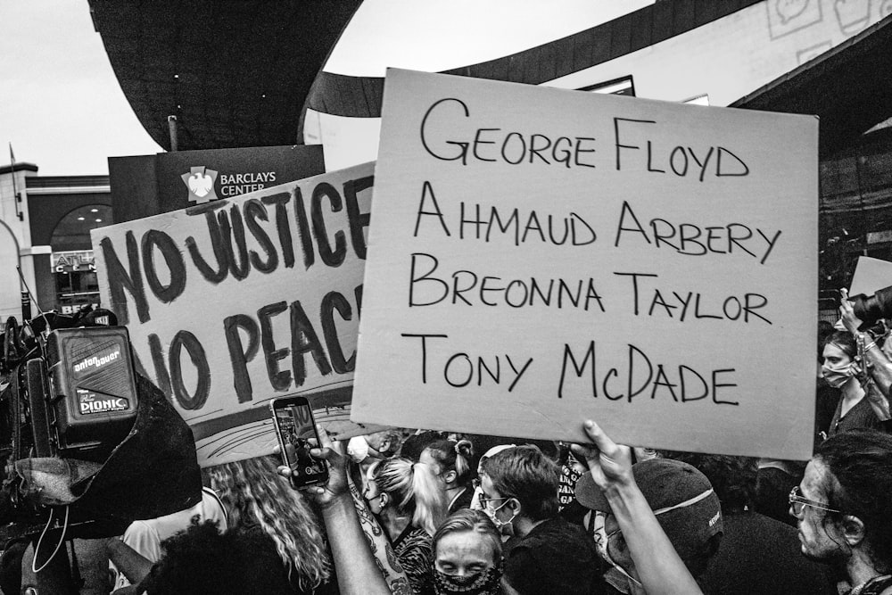 a group of people holding up signs in the air