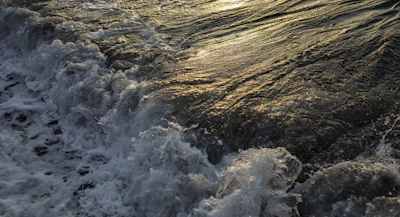 An artistic blend of ocean waves meeting a golden sunrise, symbolizing creativity and collaboration.