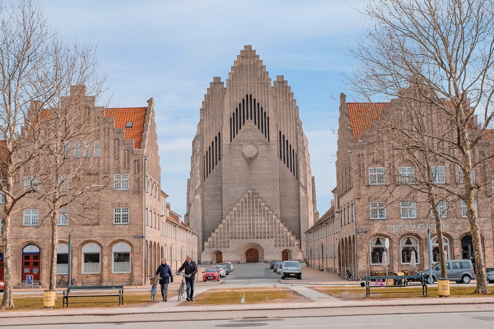 a couple of people that are standing in front of a building