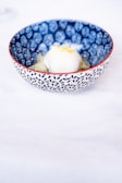 Close-up of a colorful artisanal ice cream scoop in a minimalist white bowl