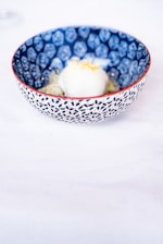 Close-up of a colorful artisanal ice cream scoop in a minimalist white bowl.