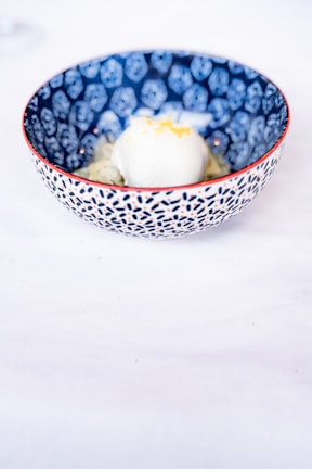 Close-up of a colorful artisanal ice cream scoop in a minimalist white bowl