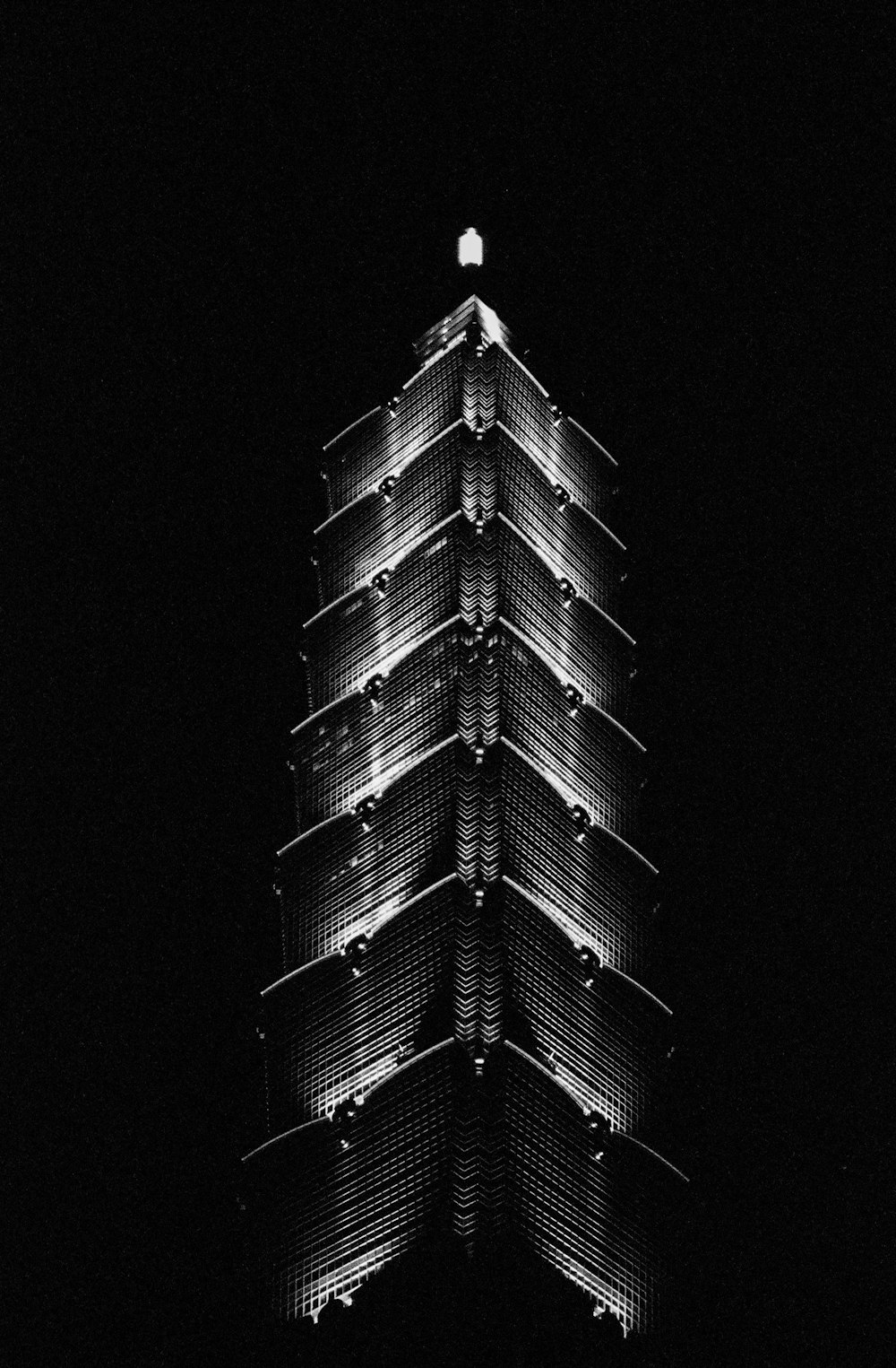 a tall building lit up in the dark