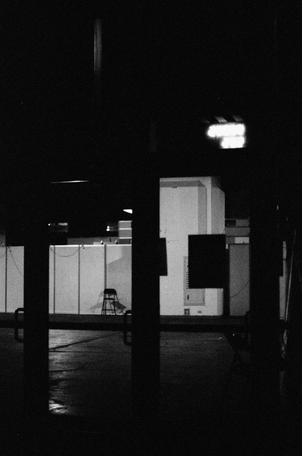 a black and white photo of a parking lot at night