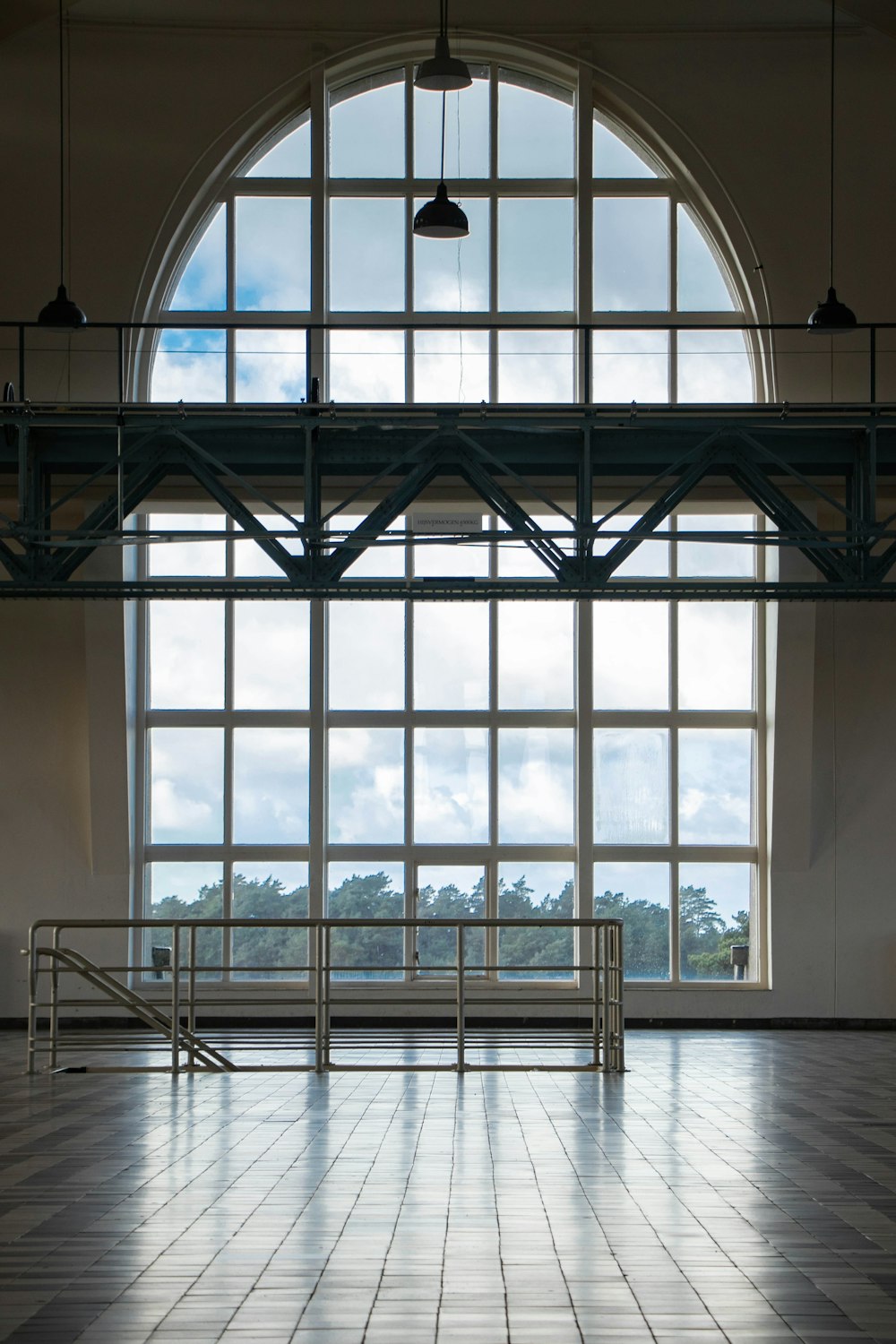 an empty room with a large window and a railing