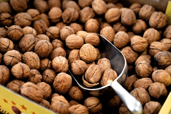 A scoop of walnuts sitting on top of a box