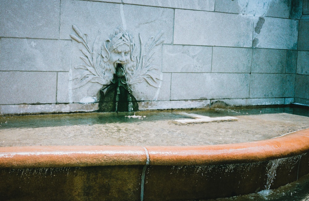 a fountain with water running down the side of it