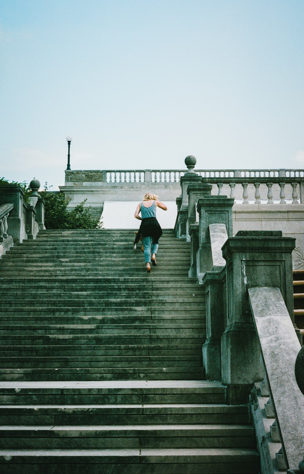 a woman walking up a flight of stairs