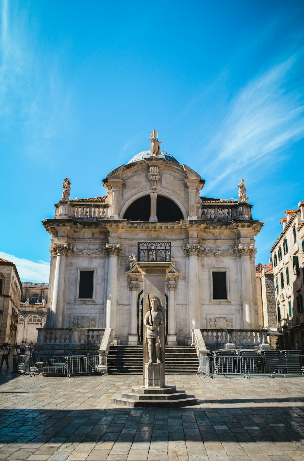 a large building with a statue in front of it