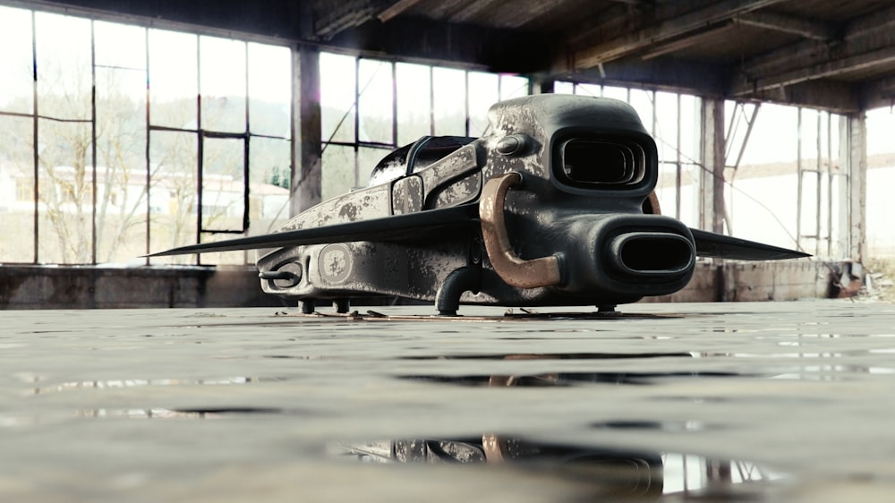 a large black object sitting in a warehouse