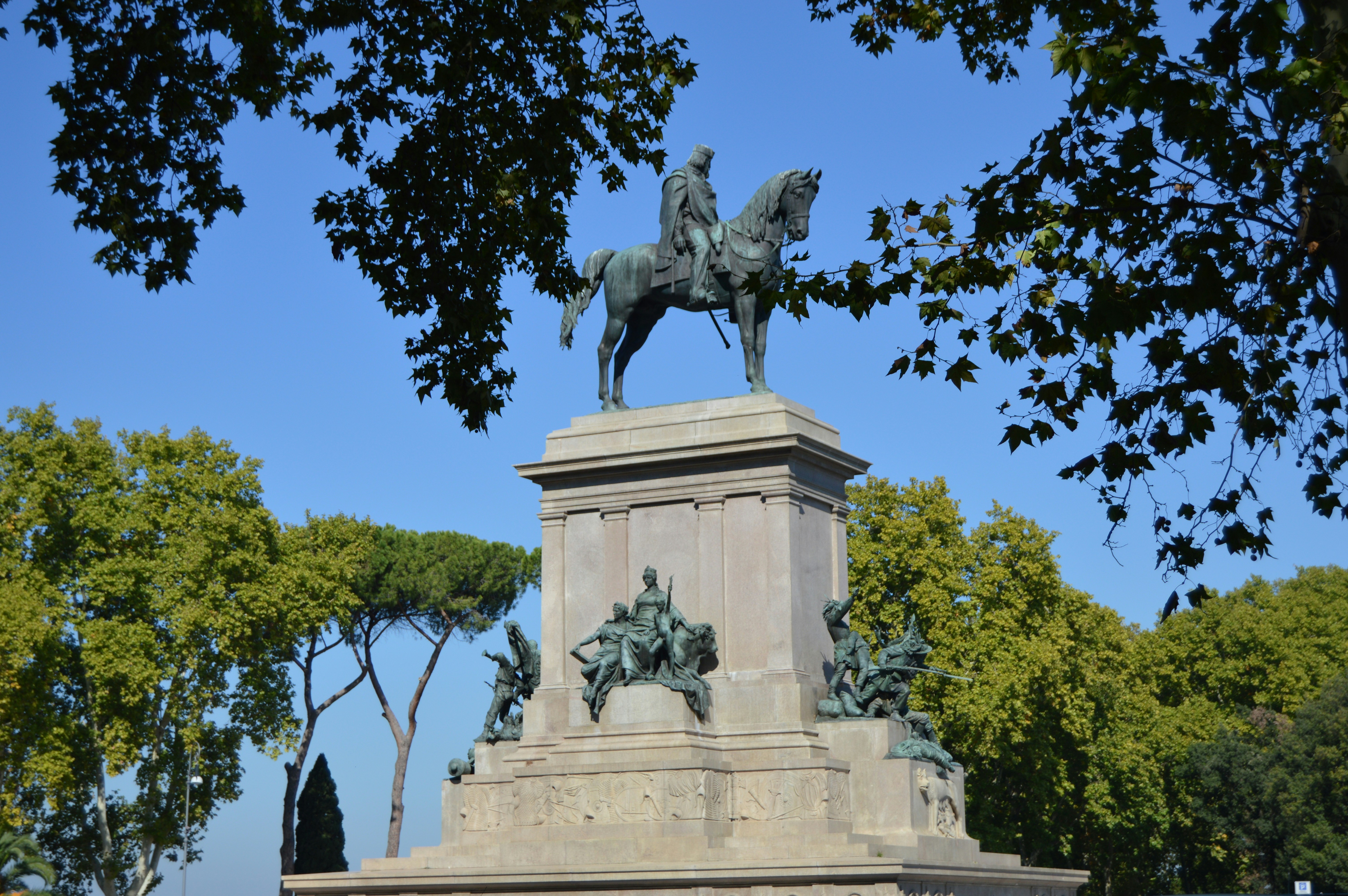 a statue of a man on a horse in a park
