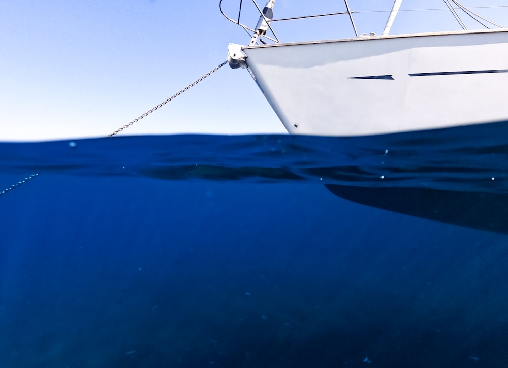 a white boat floating on top of a body of water