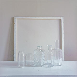 Elegant glass bottles arranged on a minimalist table.