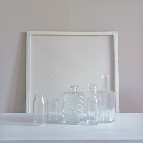 Elegant glass bottles arranged on a minimalist table.