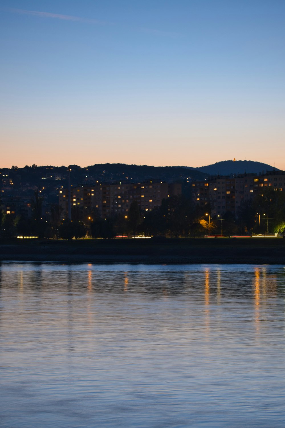 a body of water with a city in the background