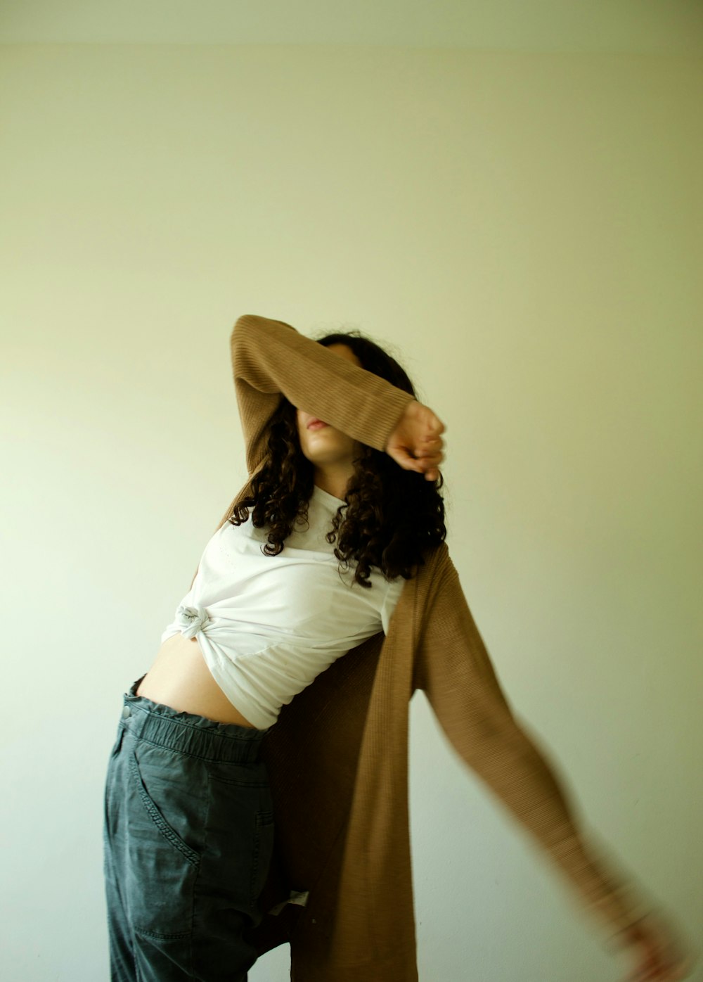 a woman in a white shirt and brown cardigan