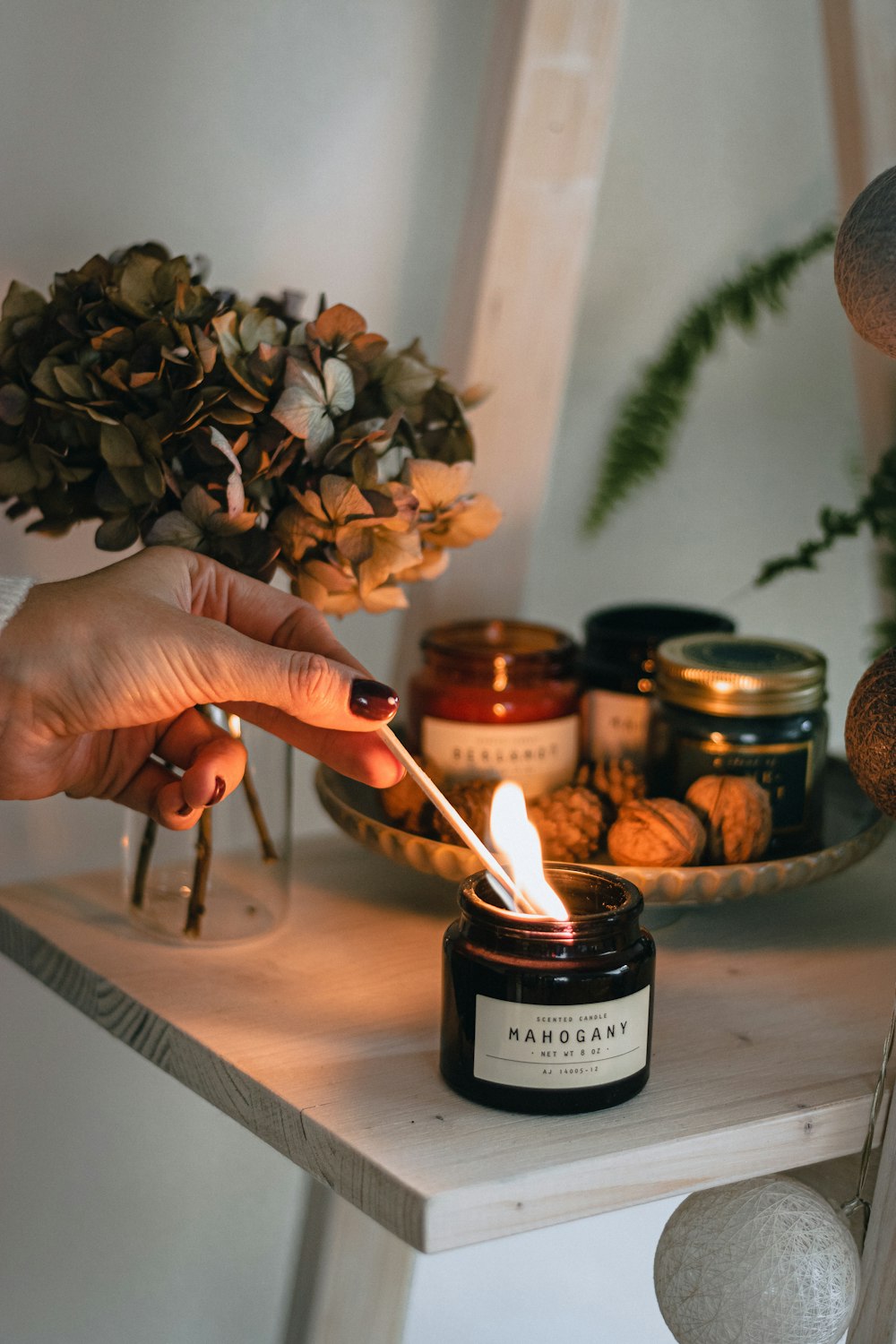 a person lighting a candle on a table