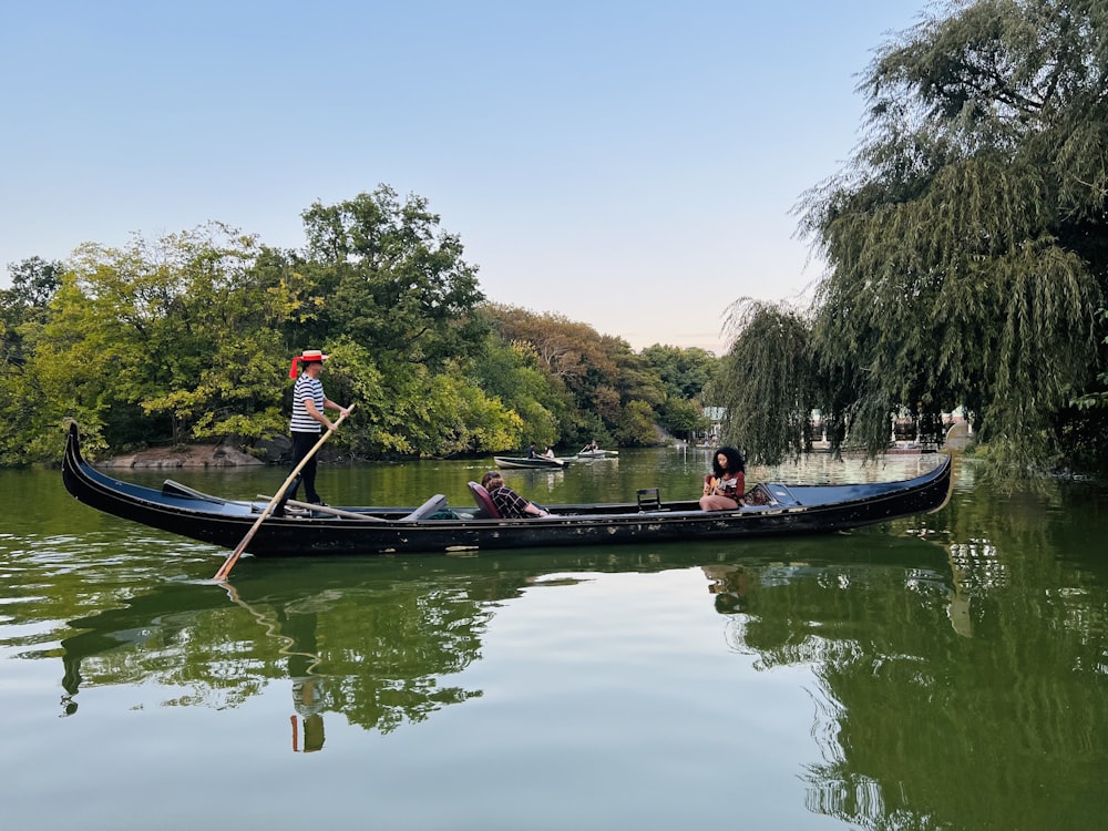 a couple of people riding in a boat down a river