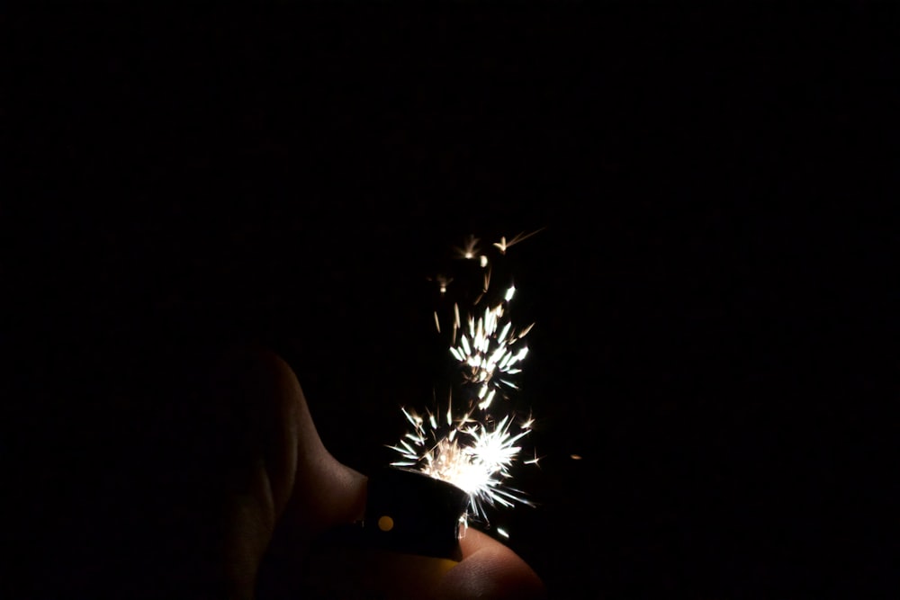 a person holding a cell phone in the dark