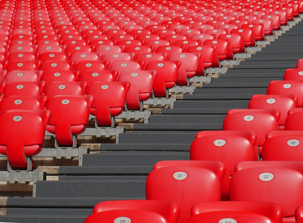 a row of red seats sitting next to each other