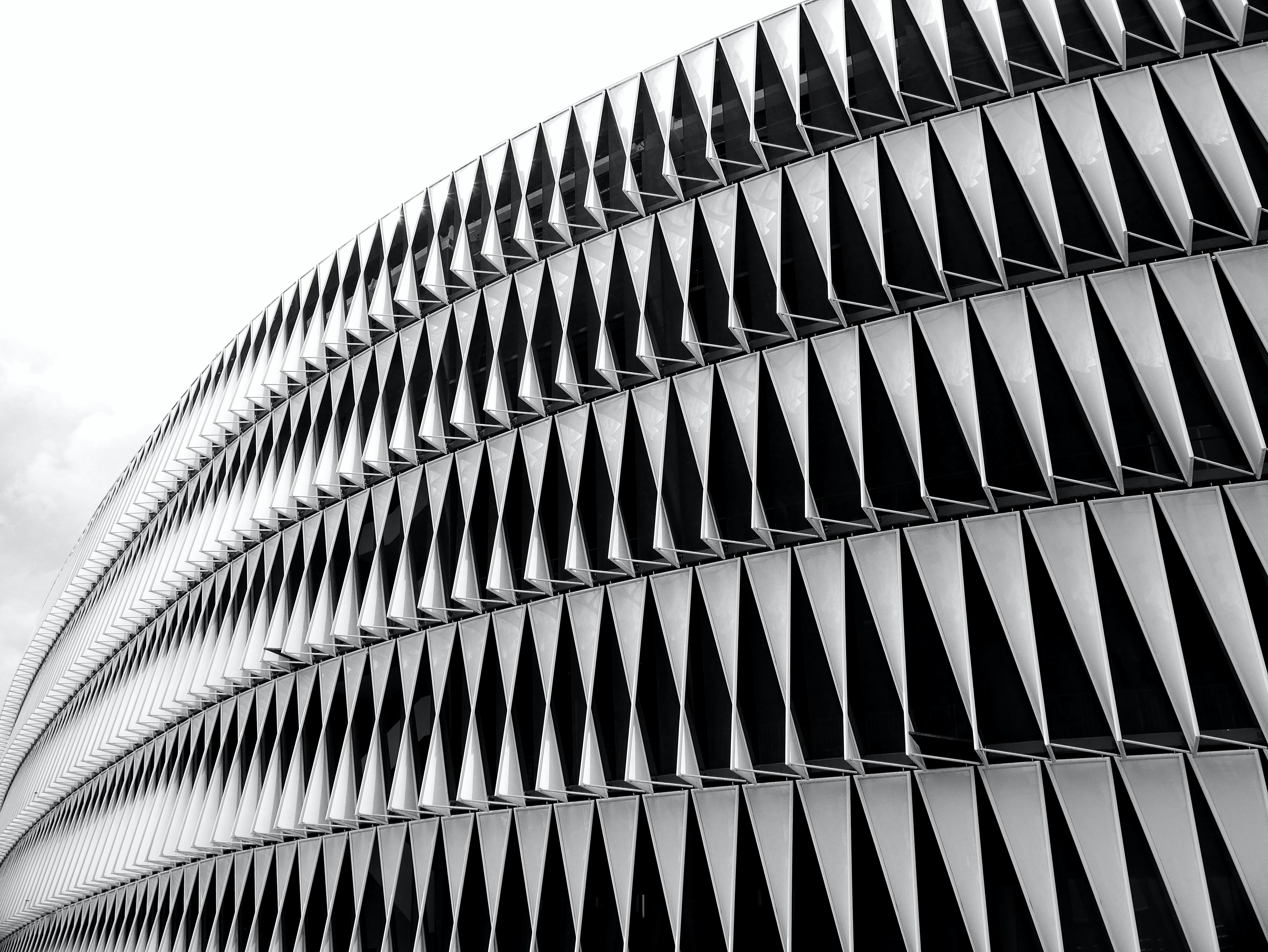 a black and white photo of a curved building