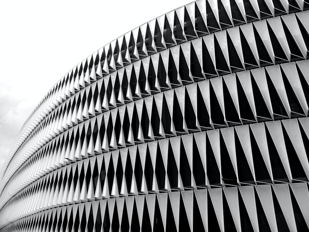 a black and white photo of a curved building