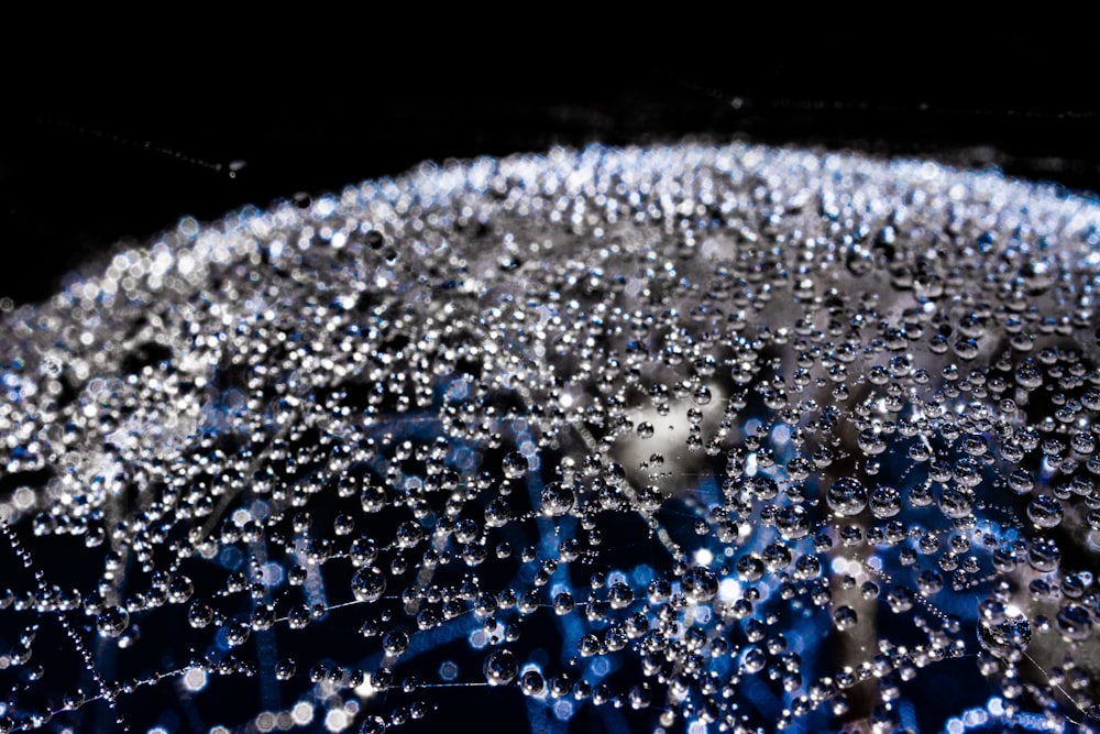a close up of water droplets on a black surface