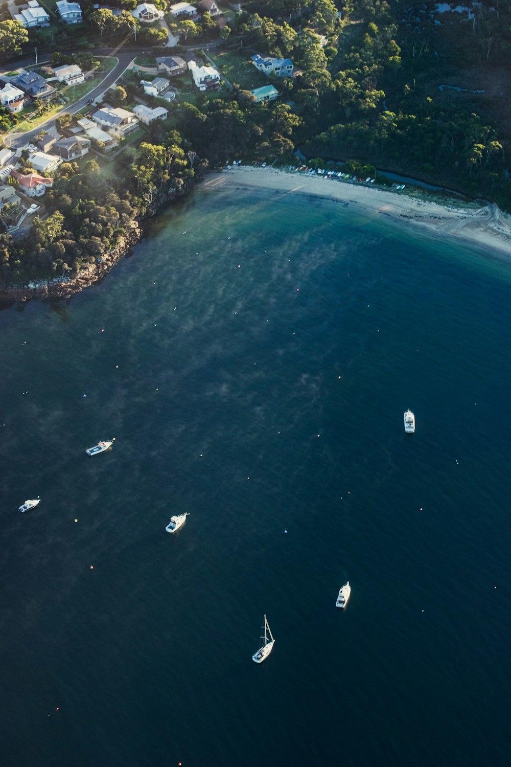 a group of boats floating on top of a body of water