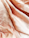 A close-up of beautifully crafted clothing pieces displayed on a soft fabric.