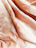 A close-up of beautifully crafted clothing pieces displayed on a soft fabric.