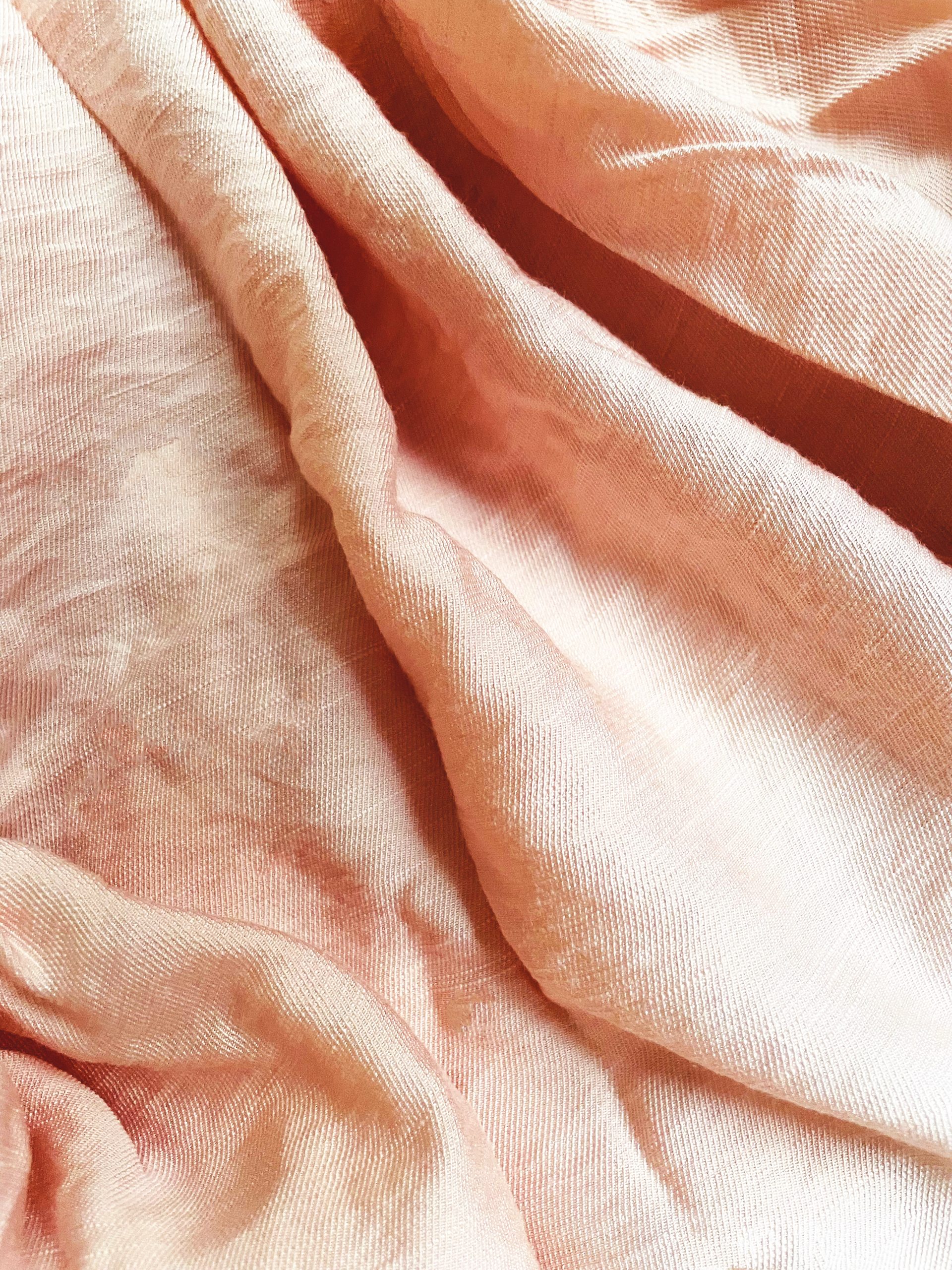 Close-up of soft, comfortable fabric textures from the chemise Clair and pull Mistral in natural light highlighting their quality.