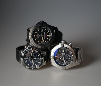 three watches sitting next to each other on a table