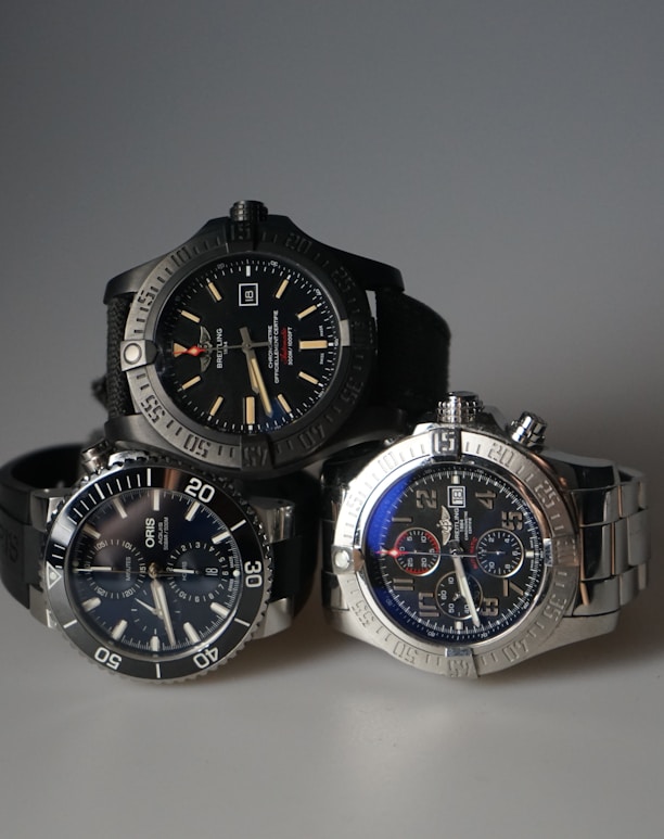 three watches sitting next to each other on a table