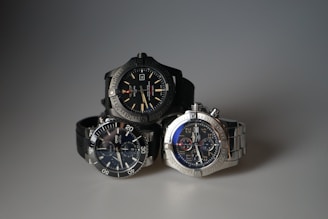 three watches sitting next to each other on a table