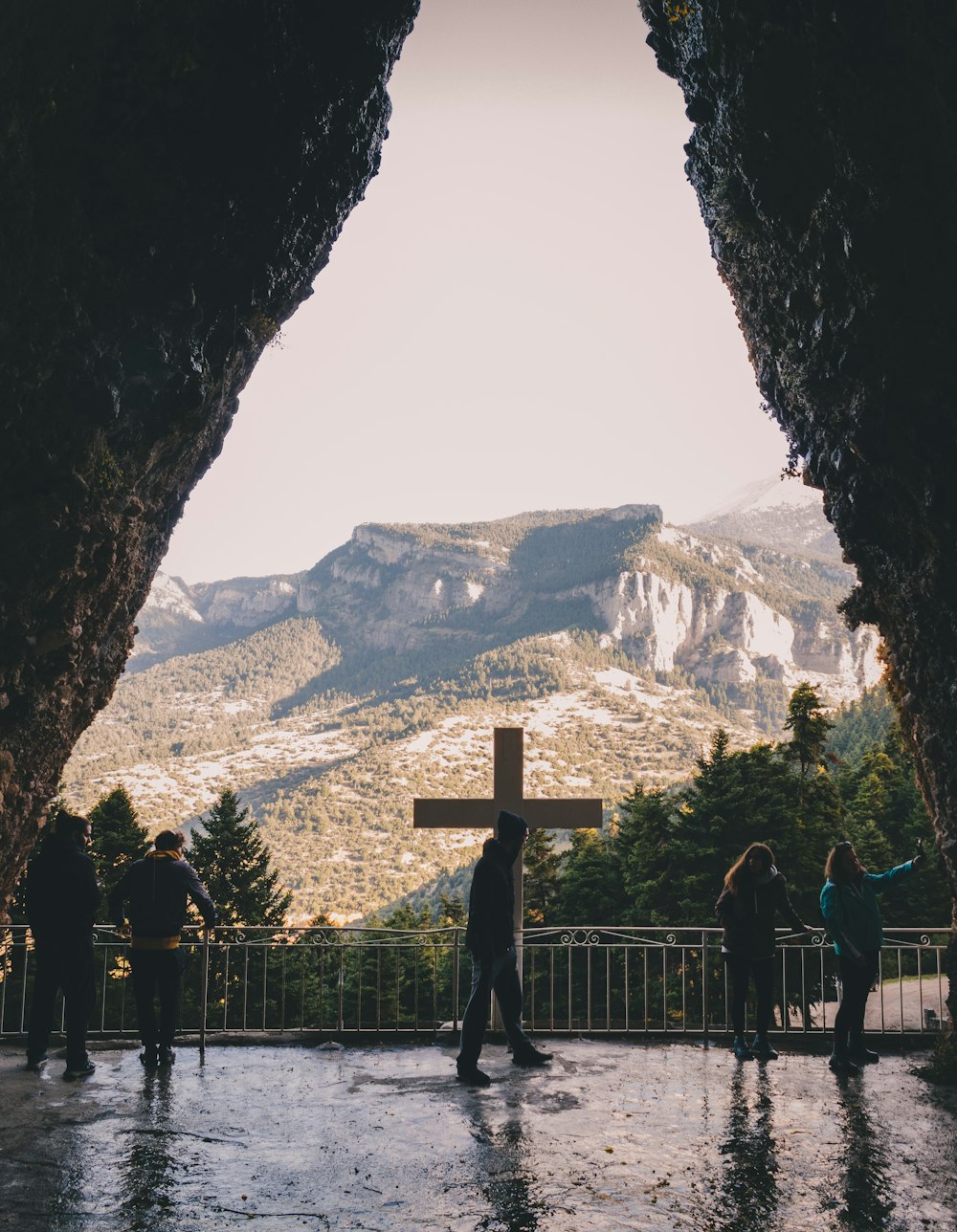 a group of people standing in front of a cross