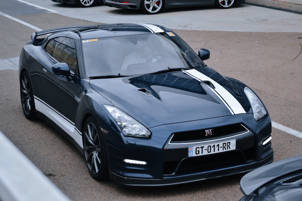 a black sports car parked in a parking lot