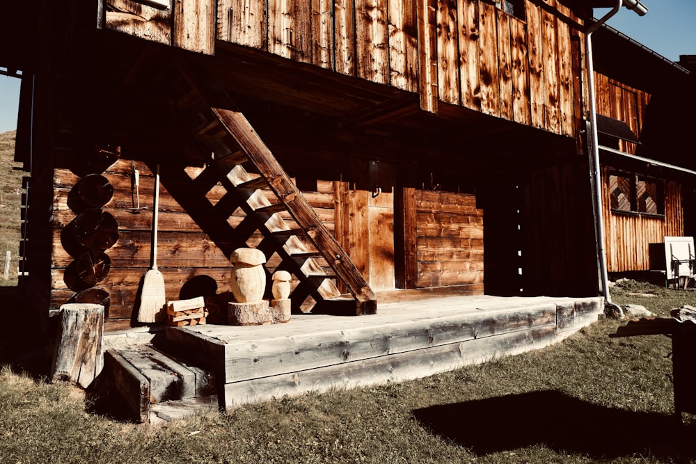 an old wooden building with a staircase leading up to it