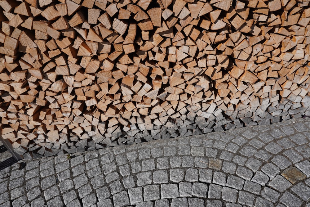 a pile of wood sitting on top of a sidewalk