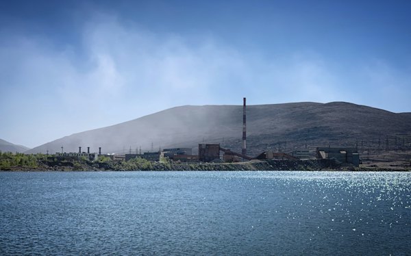 An industrial town on a lake below the hills — Murmansk, Russia