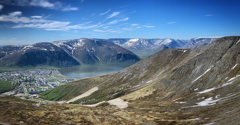 a scenic view of a town and mountains